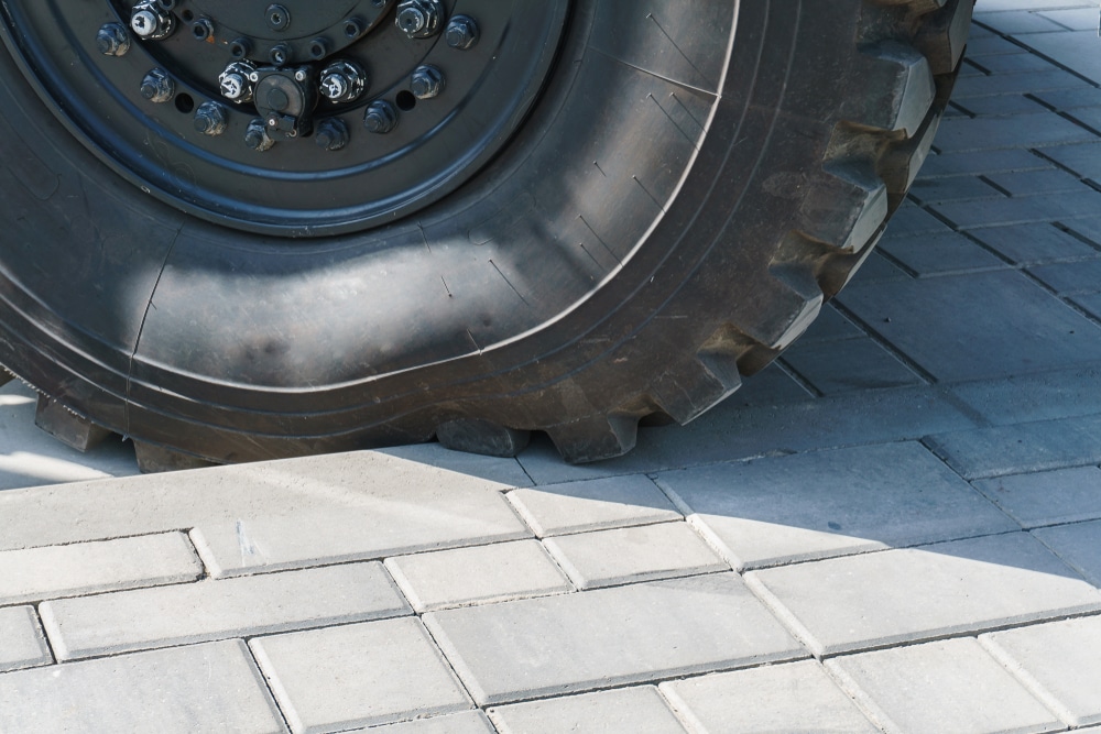 Truck tire with a deformed sidewall after being driven into a curb.