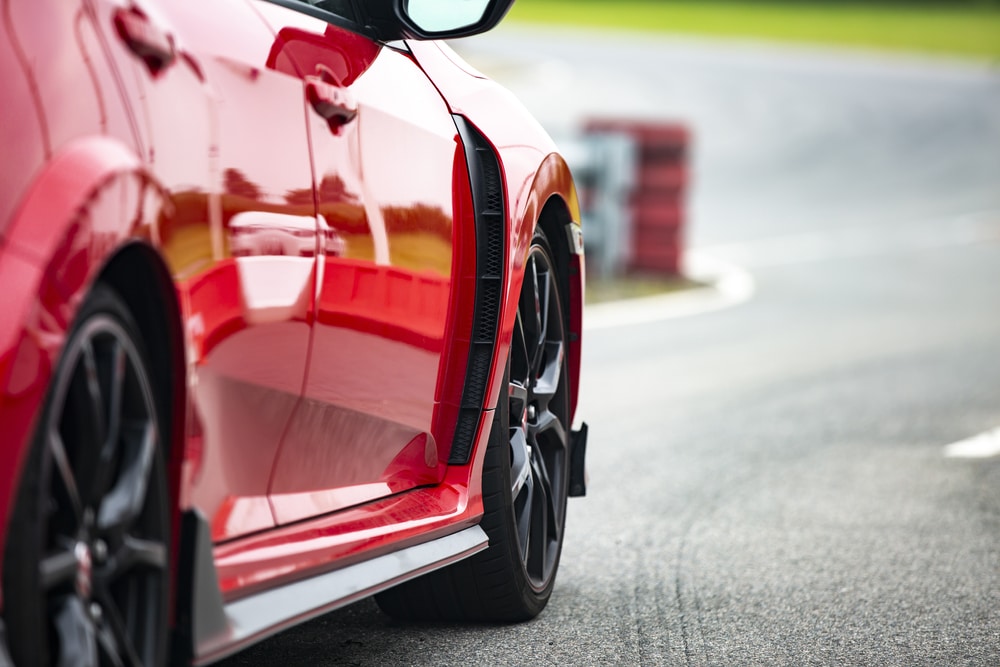 Red sports car in a race track.